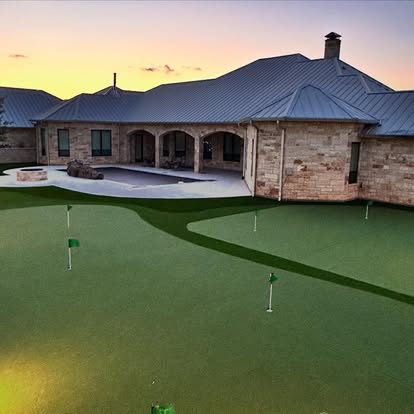Completed outdoor living space and artificial turf at sunset